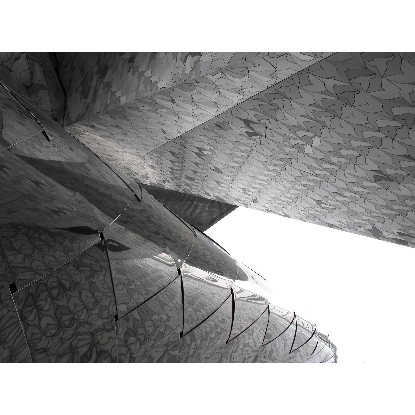 Black and white architectural photo of a modern building with an intricate roof of the Jean Novel Building in Paris. Architectural reference image echoing the rhythmic geometry of the Pleiades Asterism Bracelet
design.