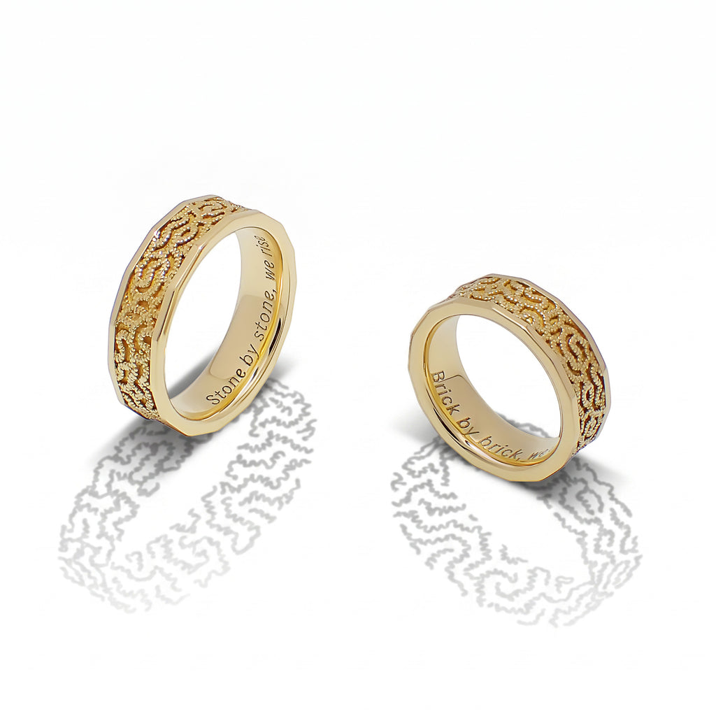 Sequana Bands shown together, their textured gold surfaces inspired by Parisian architecture.