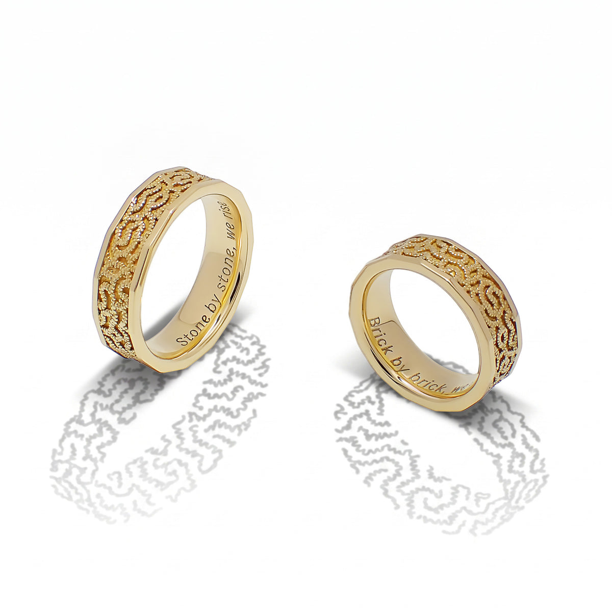 Sequana Bands shown together, their textured gold surfaces inspired by Parisian architecture.