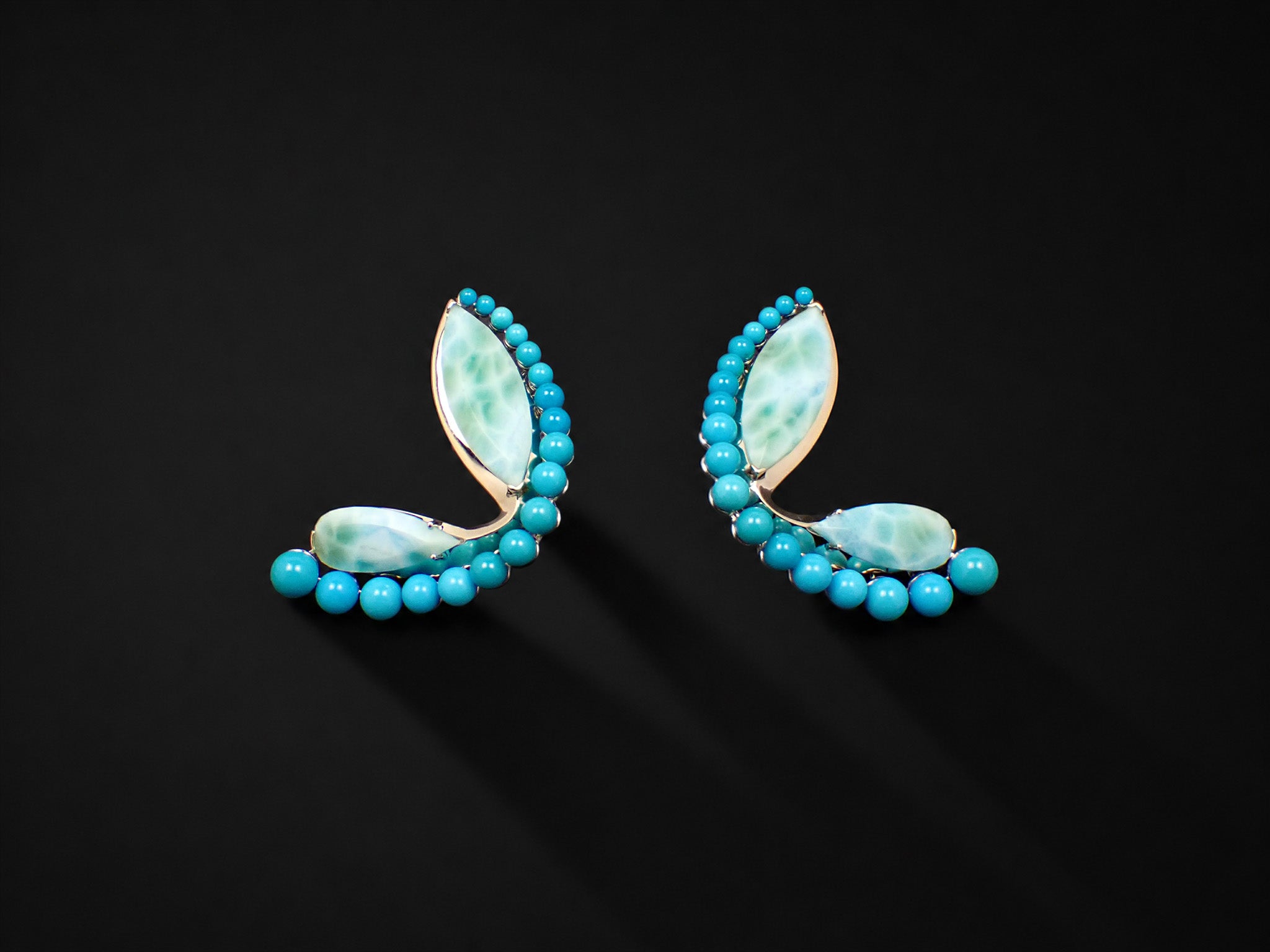 Halcyon Arc Earrings shown from the front, marquise and pear-cut larimar set in white gold with graduated turquoise cabochons.