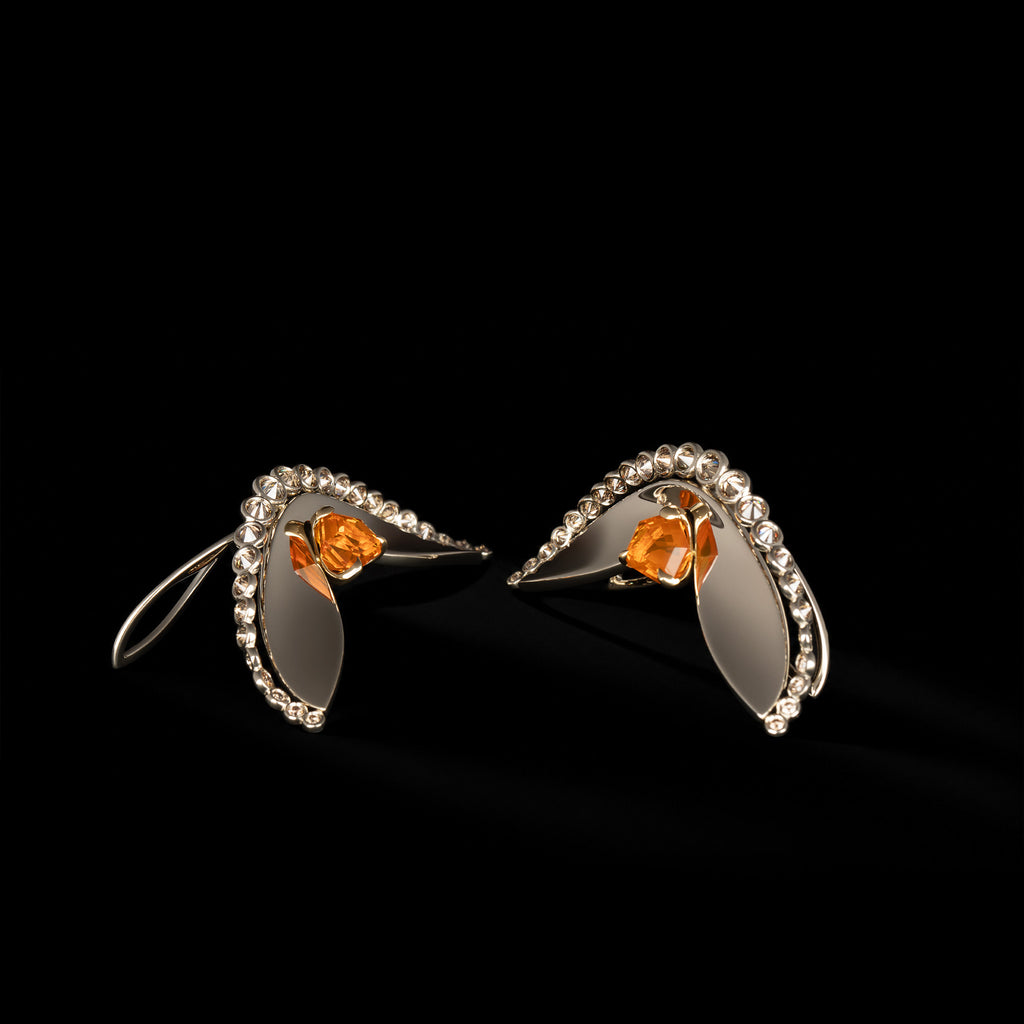 Naiad Glowfall Earrings shown as a pair against a black background, each set with a fire opal framed by champagne diamonds.