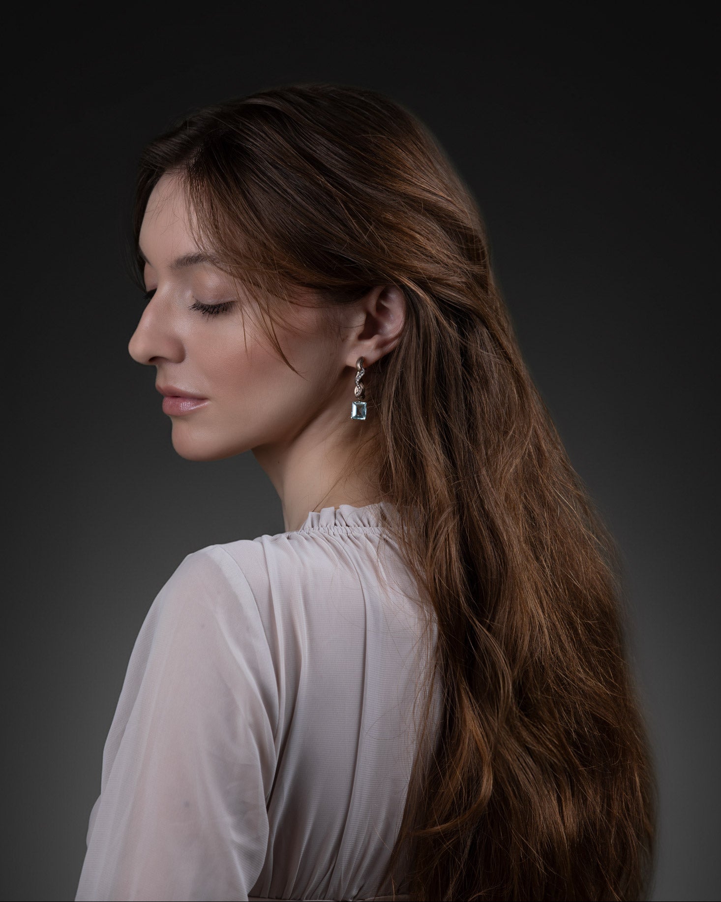 Ebb and Glint Earrings worn, showing sculptural contour and suspended aquamarine drops. Photography by Raquel Pellicano and Humberto Lemos