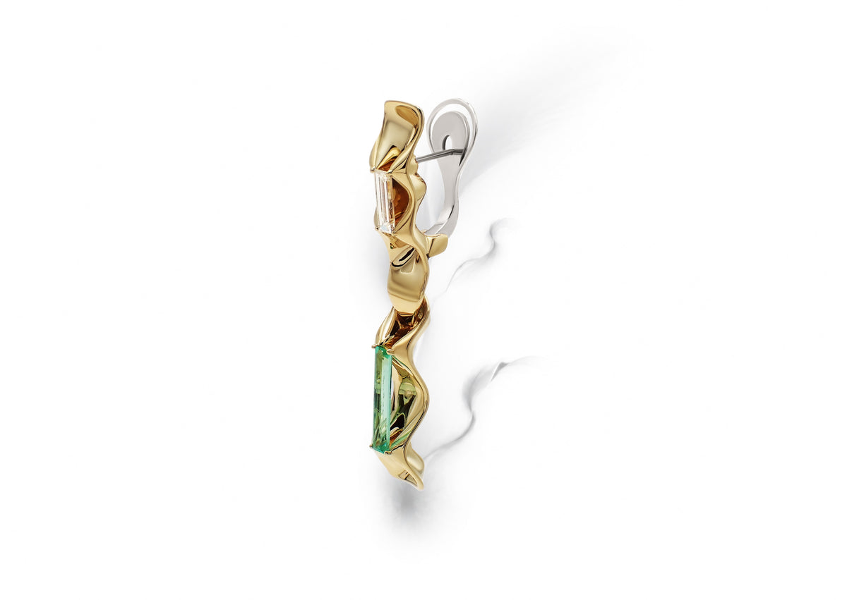 Equinox Auriga Earrings shown in side profile, baguette-cut diamonds and emeralds set within a continuous sculptural gold structure.