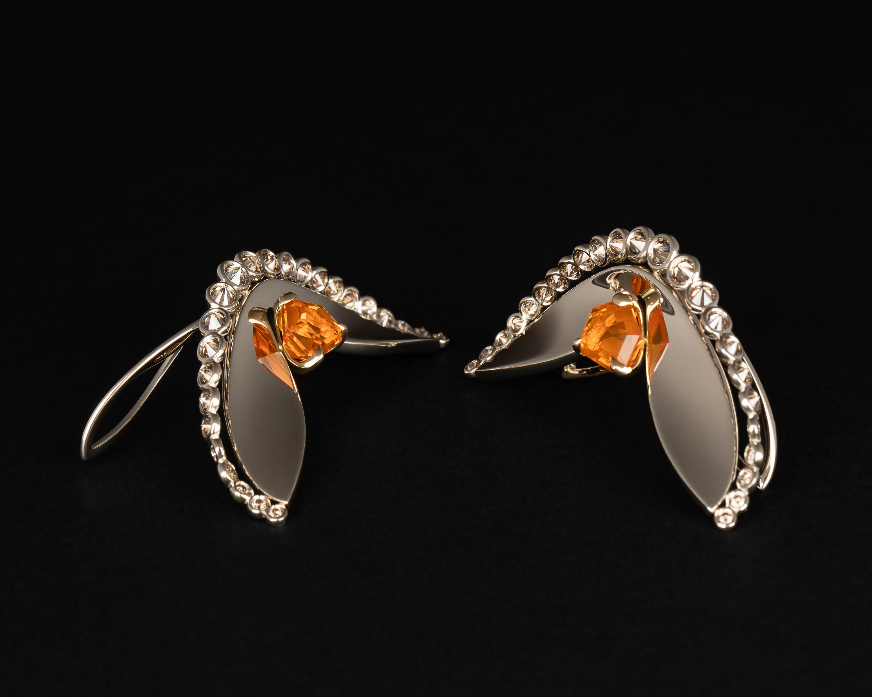 Naiad Glowfall earrings opened on dark background