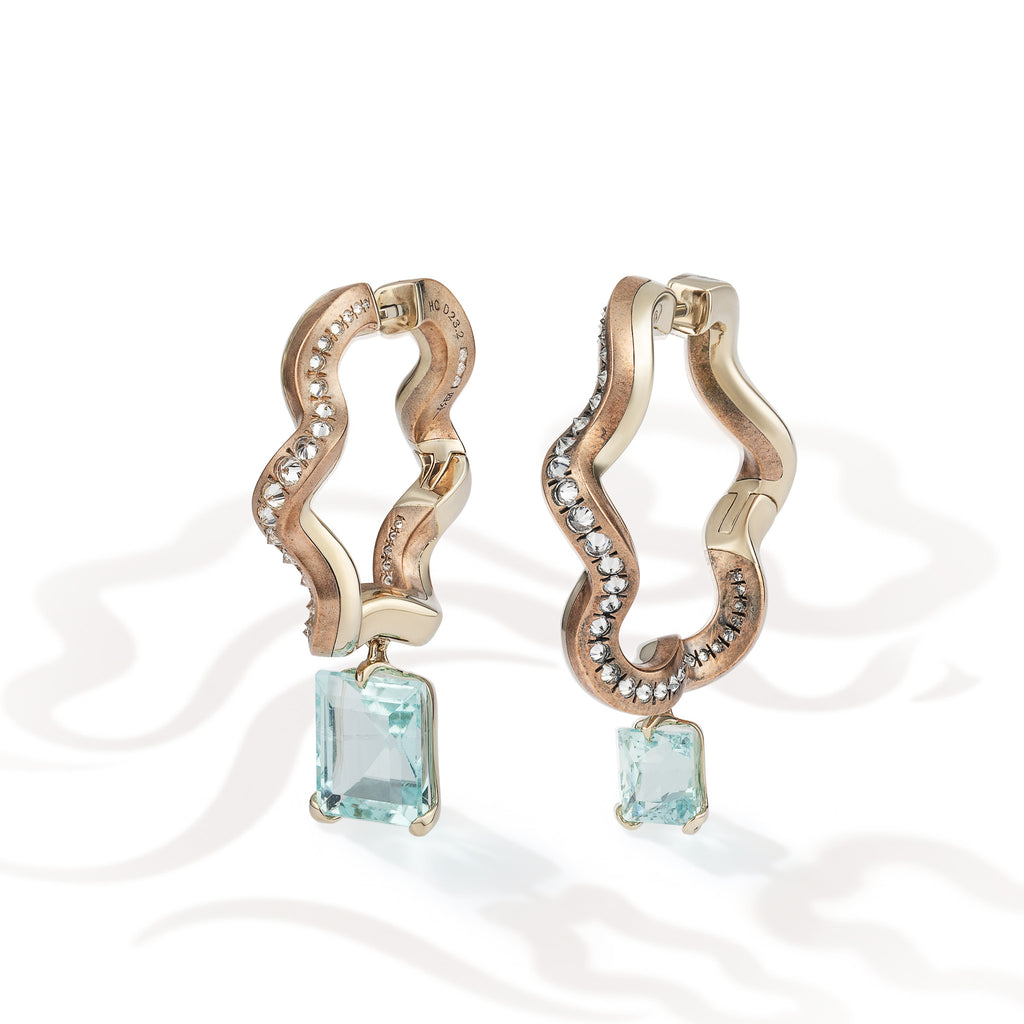 Ebb and Glint Earrings shown from the front, suspended aquamarines and reverse-set diamonds against mirror-polished beige gold and patinated shibuichi.
