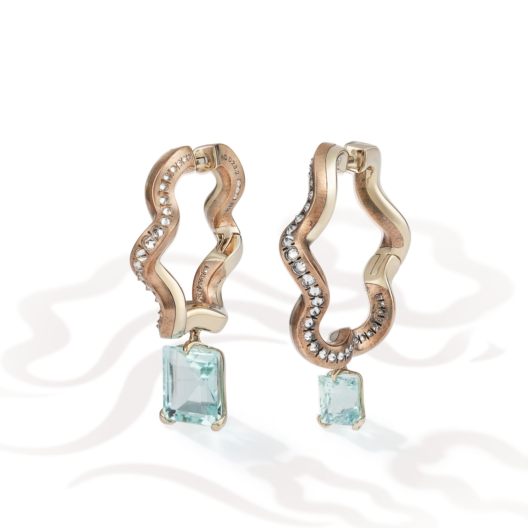 Ebb and Glint Earrings shown from the front, suspended aquamarines and reverse-set diamonds against mirror-polished beige gold and patinated shibuichi.