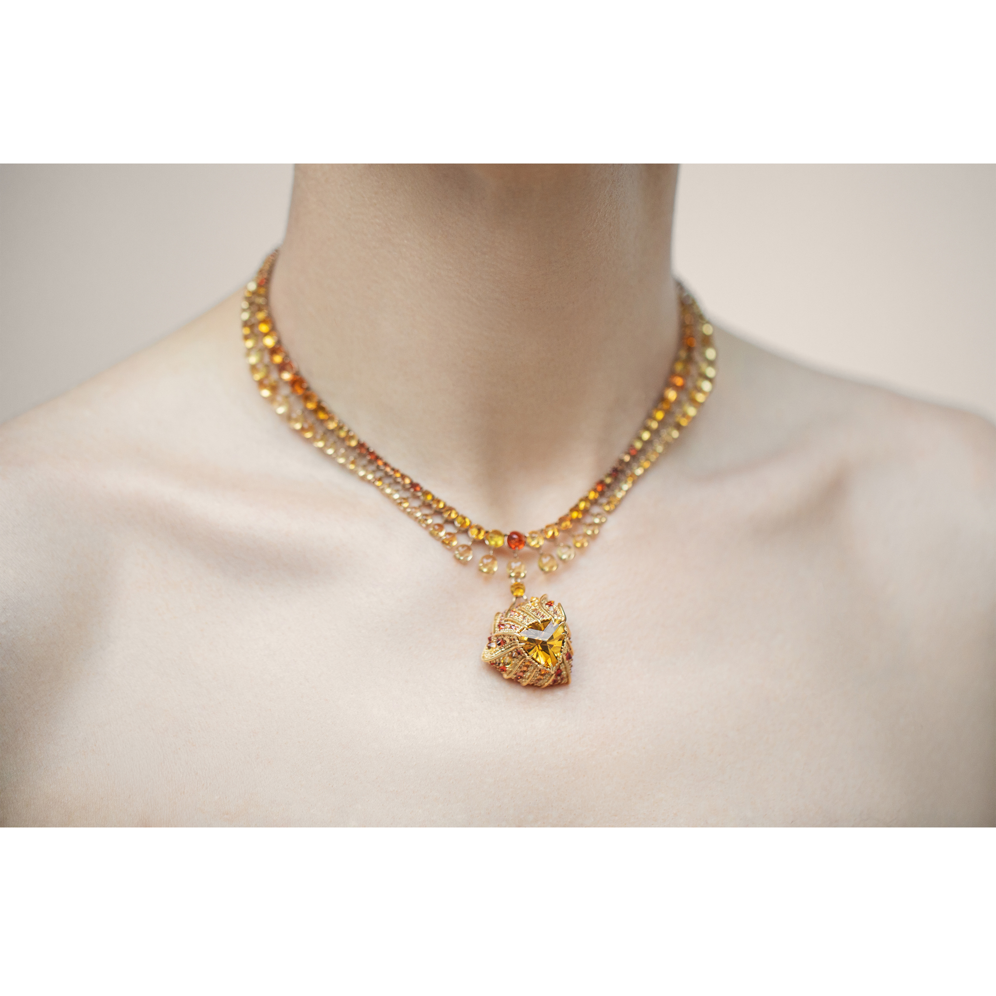 Stereón Aurion Necklace worn, showing carved gold shell and suspended citrine pendant
