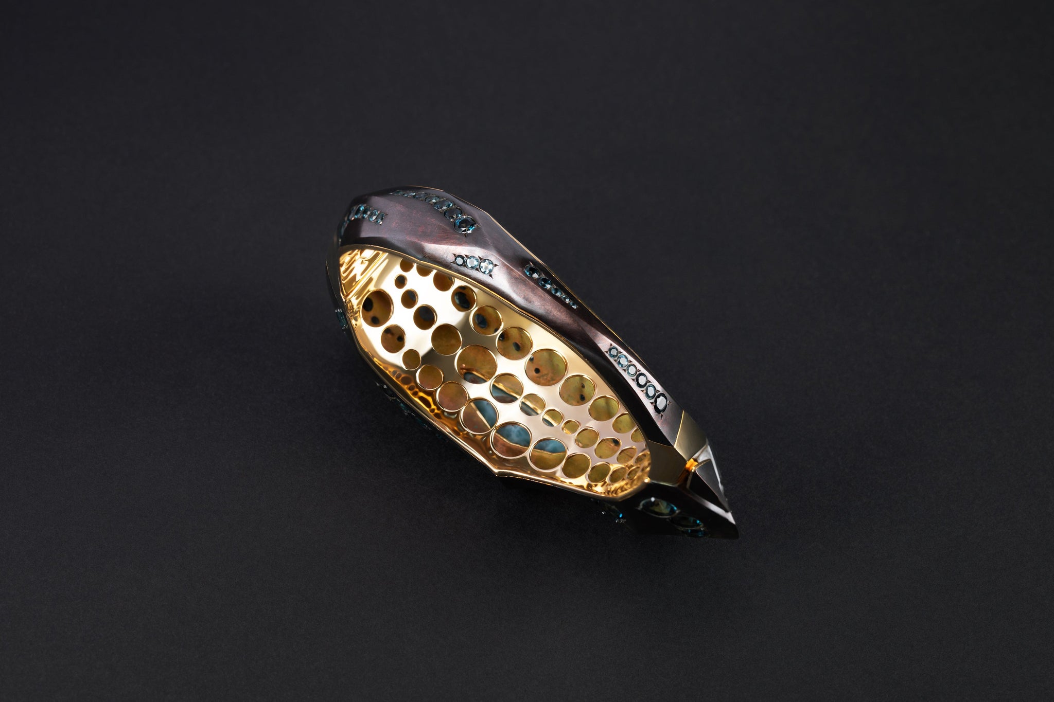 Interior view of the Phokialí Nyktos Cuff by Hugo Cahill, revealing layered structure and stone setting

