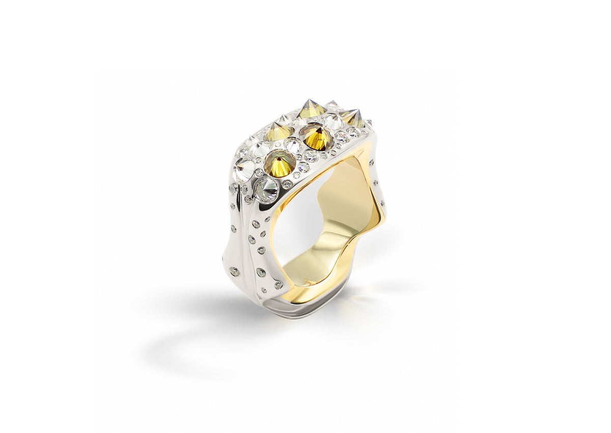 Maar Spiked Ring shown at an angle, its spiked topography of reverse-set diamonds in white, yellow and mineral tones.