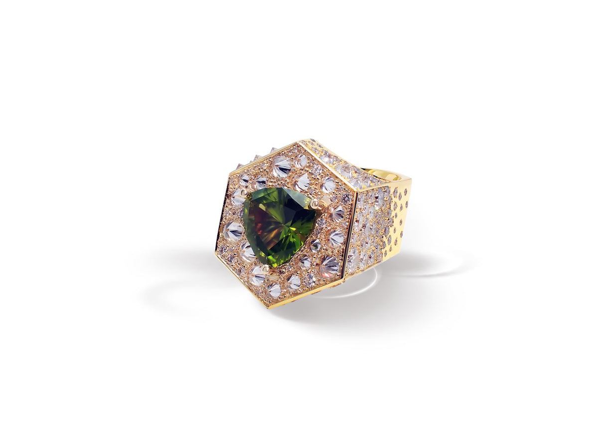 Perseya Lumen Ring shown at an angle, the trillion-cut peridot surrounded by reverse-set white diamonds.