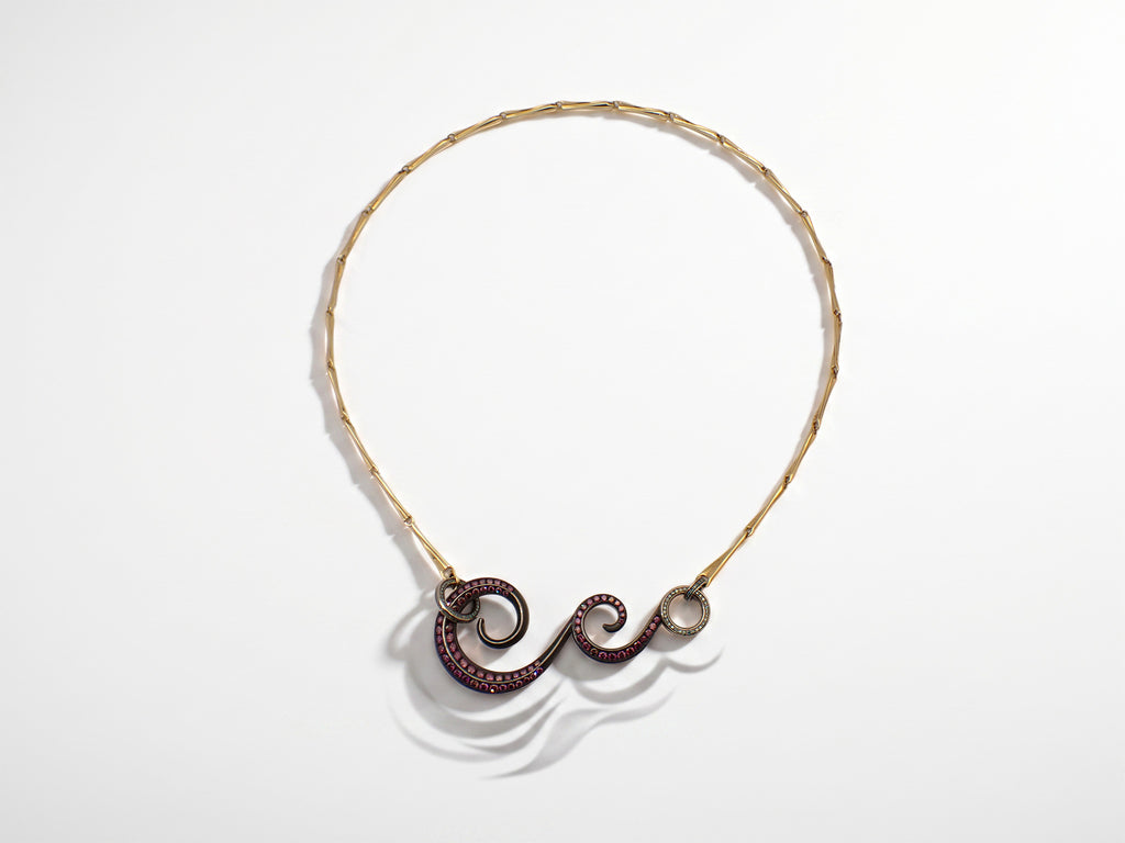 Lovelace Volute Necklace shown from the front, mauve, pink and blue-green diamonds set across beige gold, yellow gold and waxed oxidised silver.