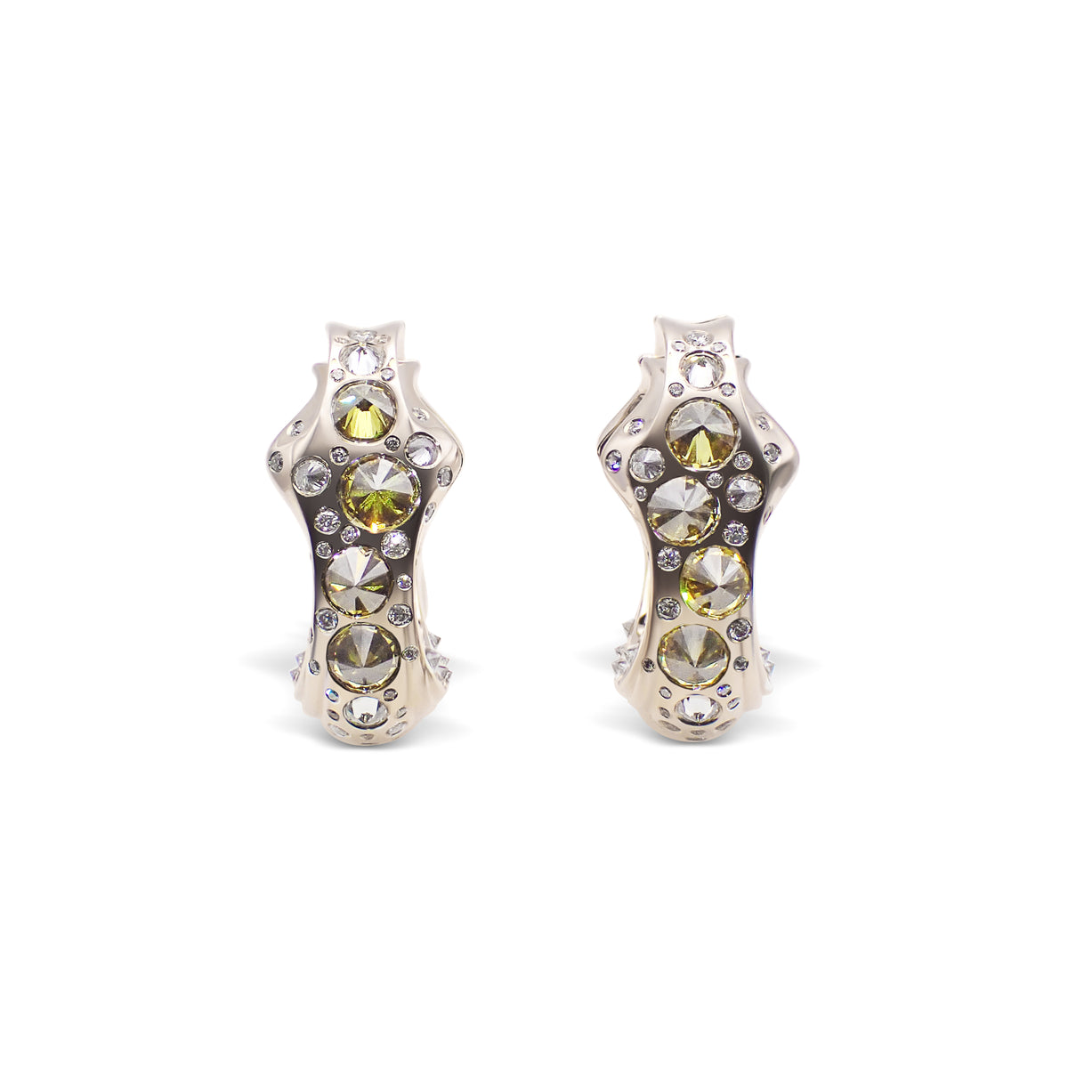 A pair of spike-shaped earrings with a combination of white and yellow diamonds set in beige gold, with orange and brown undertones. Tephra Spiked Earrings by Hugo Cahill featuring clusters of inverted diamonds
