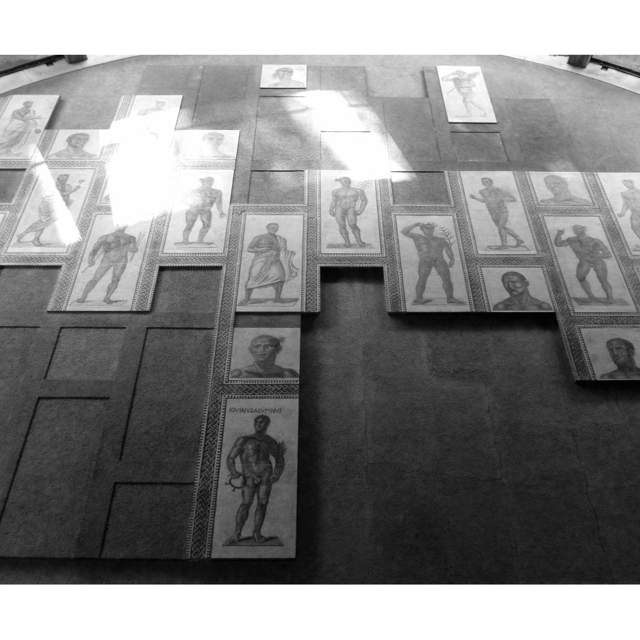 Collection of black and white portraits on a textured surface, Roman Mosaic at the Vatican. Atelier process image related to the making of the bespoke Ruby Wedding Bands
